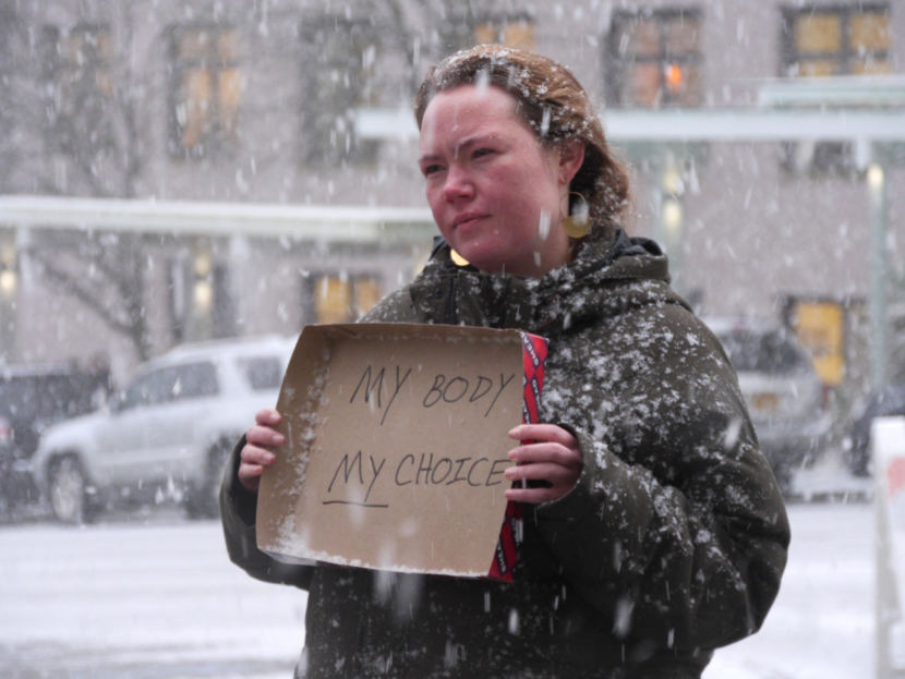 Alicia Hughes-Skandijs quietly counter-protests an anti-abortion rally outside the Alaska State Capitol on Monday, Jan. 22, 2018. About 150 people attended the event organized by Alaskans for Life.
