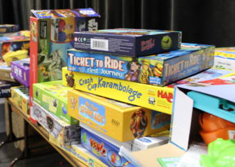 A player selects a game from the children's game library at Platypus Con on Jan. 28, 2017. (Photo by Adelyn Baxter/KTOO)