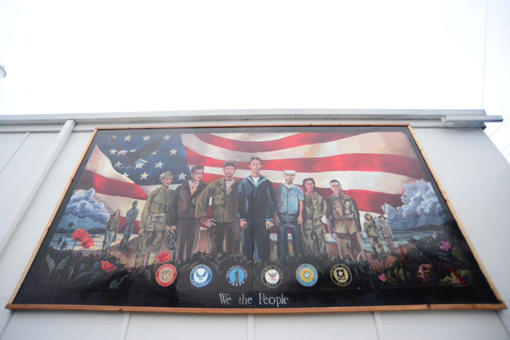 A new mural by Merrick Bochart hangs at American Legion Post 12 in Haines. (Photo by Berett Wilber/KHNS)
