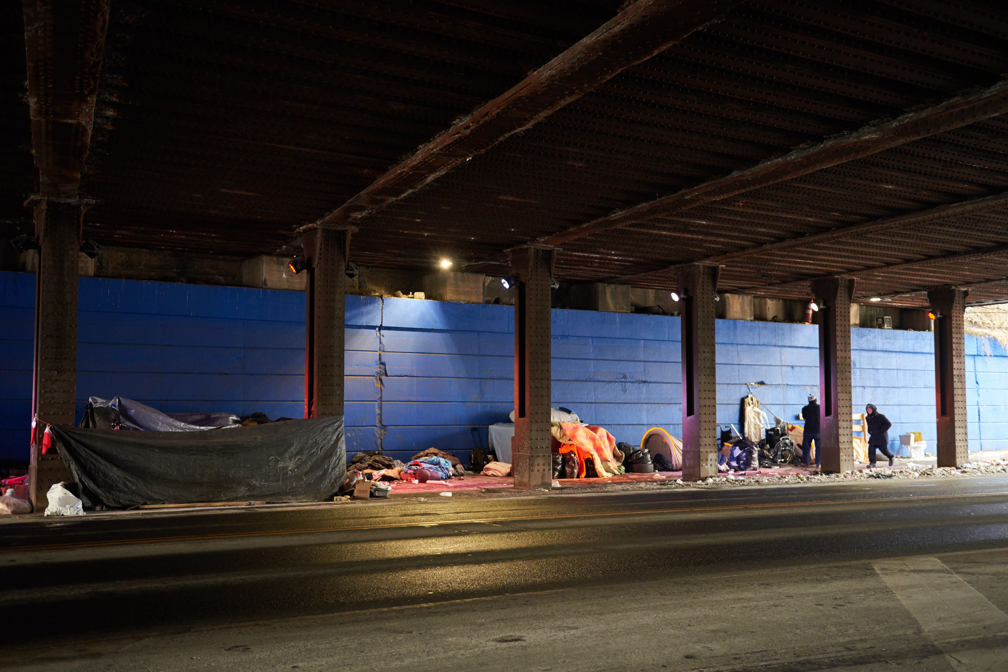 The mix of people in rows of tents under a bridge in Philadelphia's Kensington neighborhood includes homeless adults and some visitors from the suburbs who come here to inject opioids in secret. (Photo by Natalie Piserchio/WHYY)