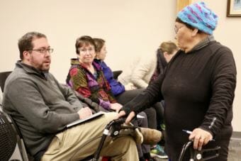 District 38 Representative Zach Fansler speaking with Bethel resident Mary Nanuwak at the December 12, 2017 Bethel City Council meeting. Fansler is accused of hitting a woman when she tried to leave his hotel room. (Photo by Christine Trudeau/KYUK)
