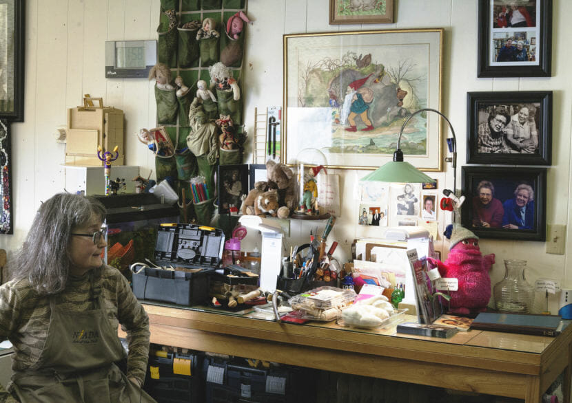 Mary Ellen Frank shows off her studio and work space at Aunt Claudia's Dolls museum in downtown Juneau. Frank creates custom dolls and owns an extensive collection of Alaskan Native doll art. (Photo by Tripp J Crouse/KTOO)