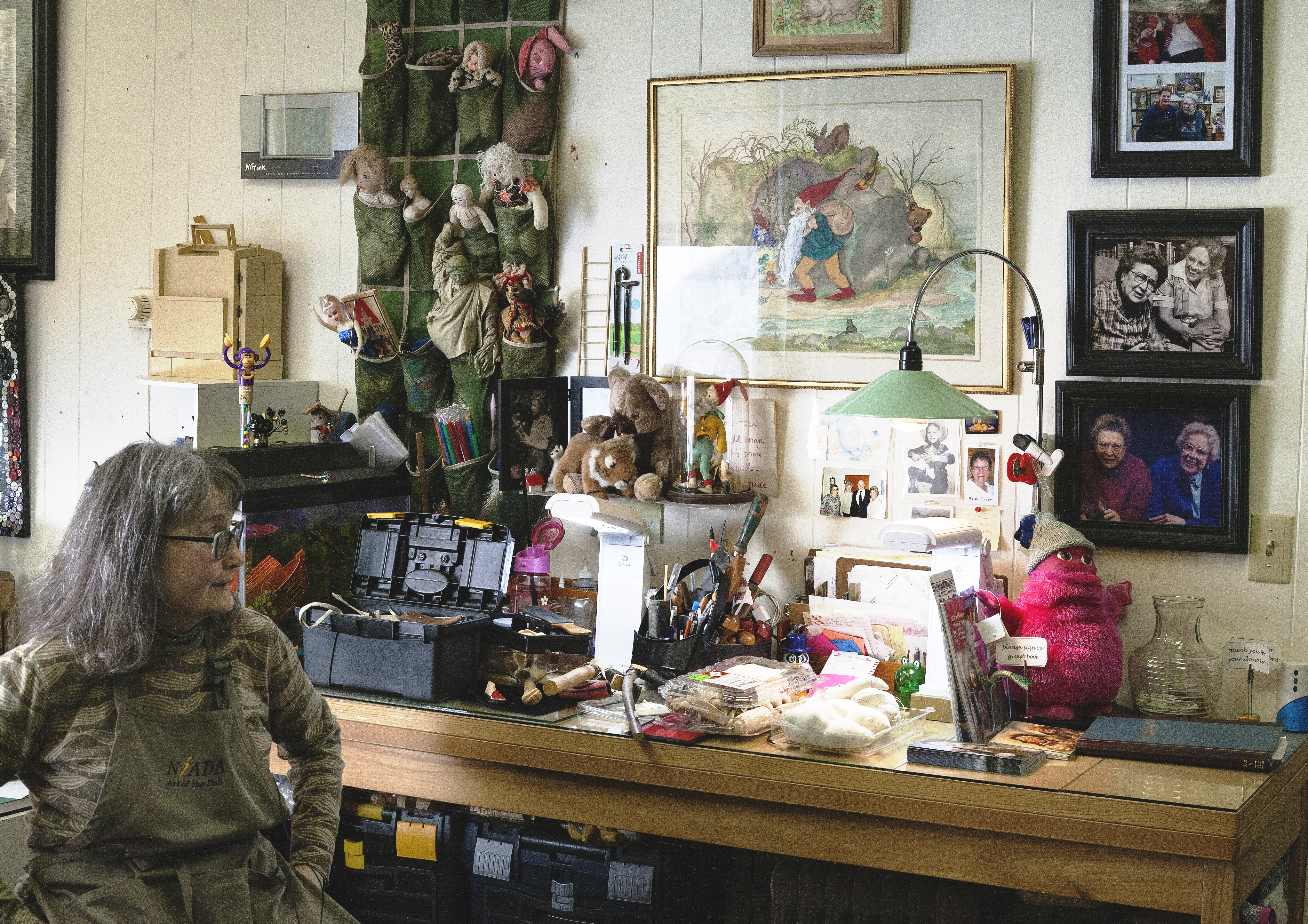 Mary Ellen Frank shows off her studio and work space at Aunt Claudia's Dolls museum in downtown Juneau. Frank creates custom dolls and owns an extensive collection of Alaskan Native doll art. (Photo by Tripp J Crouse/KTOO)