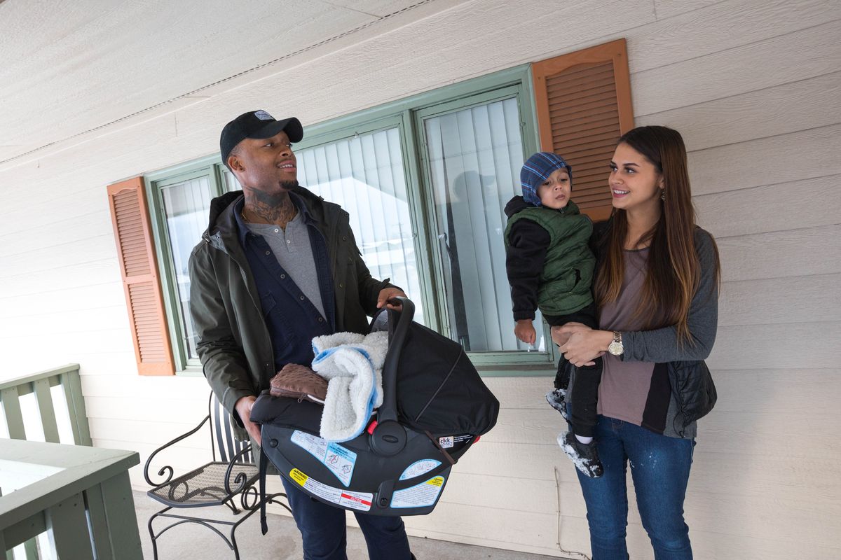 David Dumpson, left, holds newborn Kahleel, and fiancee Hannah Johnson, holds their 2-year-old son Kohen, as they check out an apartment in East Anchorage on Tuesday. (Photo Loren Holmes / ADN)