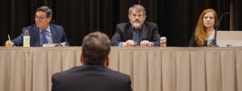 Independent hydropower entrepreneur Duff Mitchell participates in public comment at a Regulatory Commission of Alaska meeting at Centennial Hall in Juneau on Tuesday, Feb. 27, 2018. Mitchell is the managing director of Juneau Hydropower Inc. Facing from left to right: RCA Chairman Stephen McAlpine, Administrative Law Judge James L. Walker and Commission Section Manager Kristin Schubert.