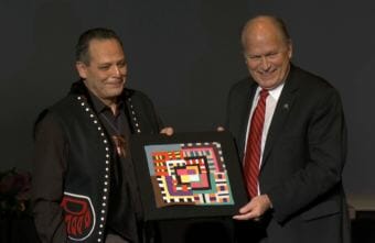 Sitka carver and educator Charlie Skultka Jr. receives the Margaret Nick Cooke Award for Alaska Arts and Languages from Gov. Bill Walker at the Governor's Arts and Humanities Awards gala in Juneau on Feb. 8, 2018.
