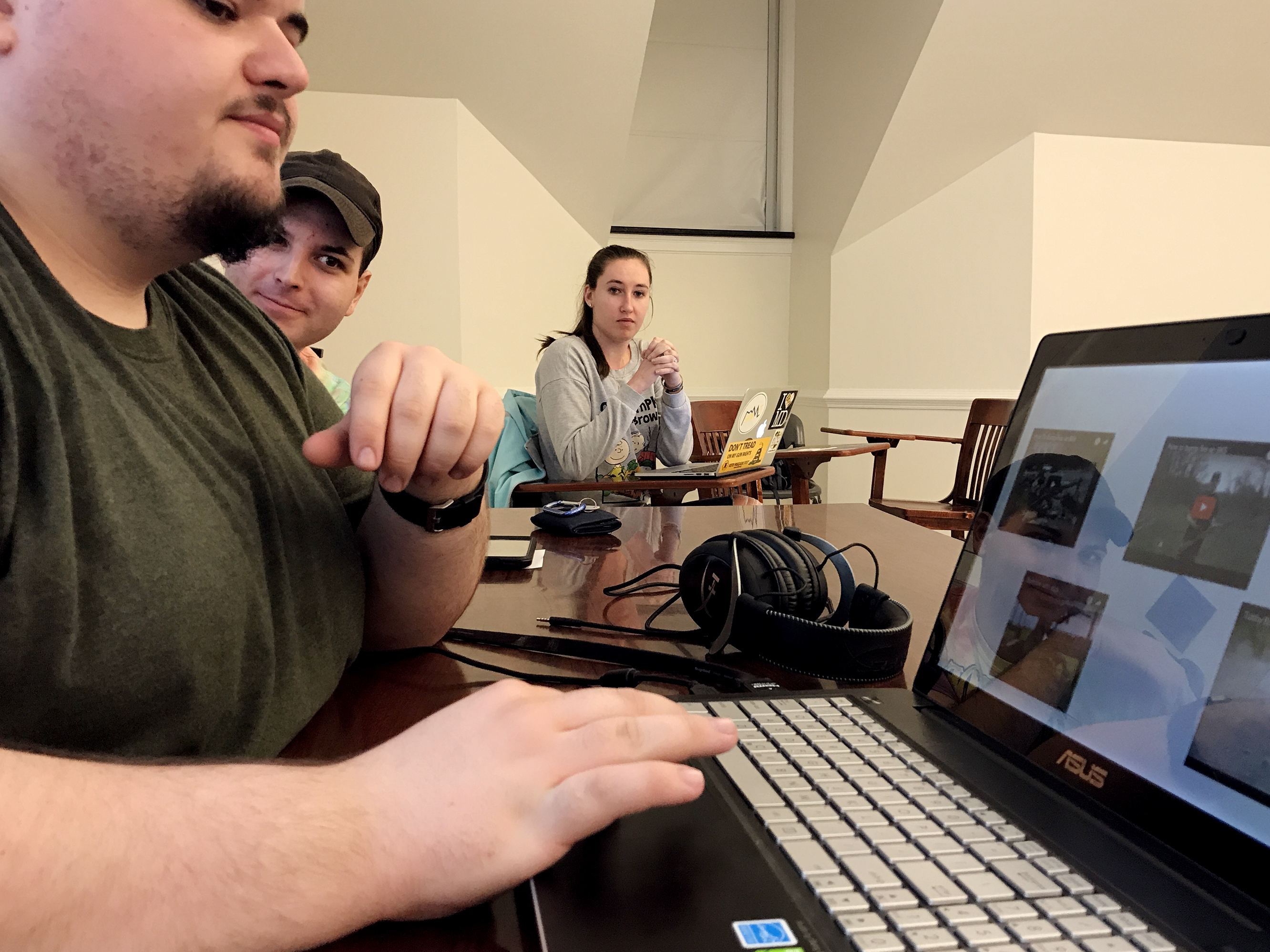 Kyle Schmitt (from left), Owen Uber and Jordan Riger watch videos of firearm demonstrations at a meeting of Students for the Second Amendment. According to its website, the student group wants to "erase the negativity associated with firearms" at the University of Delaware. (Photo by Hansi Lo Wang/NPR)