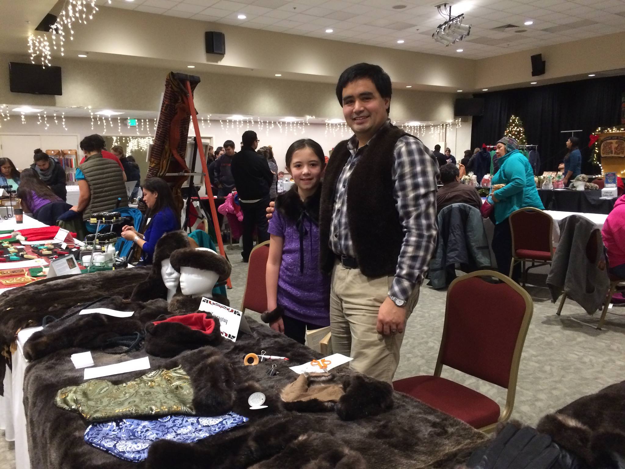 Marcus Gho poses with his daughter at his craft table at the Native Artists Market in November 2016. (Photo courtesy Marcus Gho)