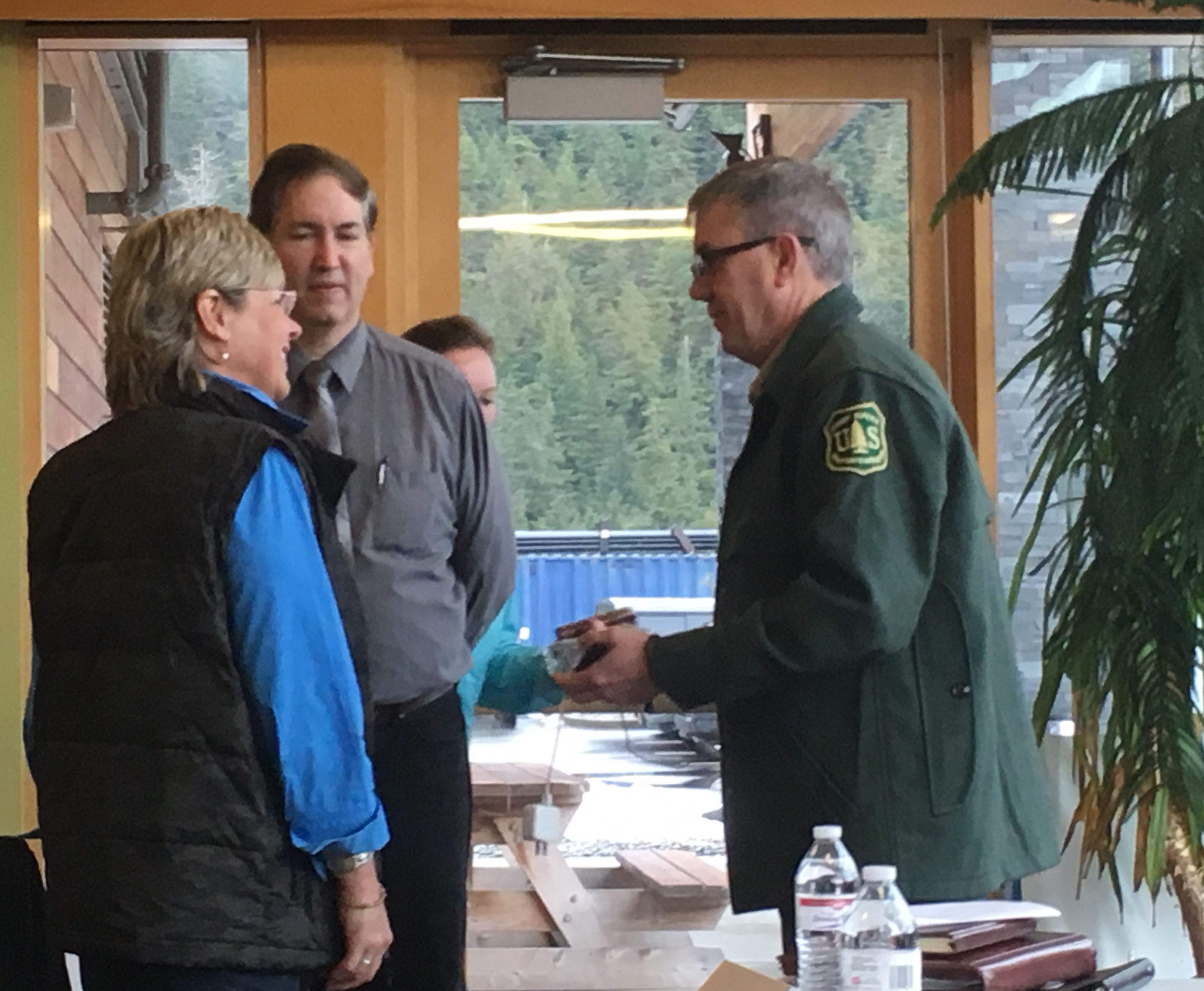Forest Service Chief Tony Tooke, right, talks with panelists before Friday’s event at the Ketchikan library. (Photo by Leila Kheiry/KRBD)