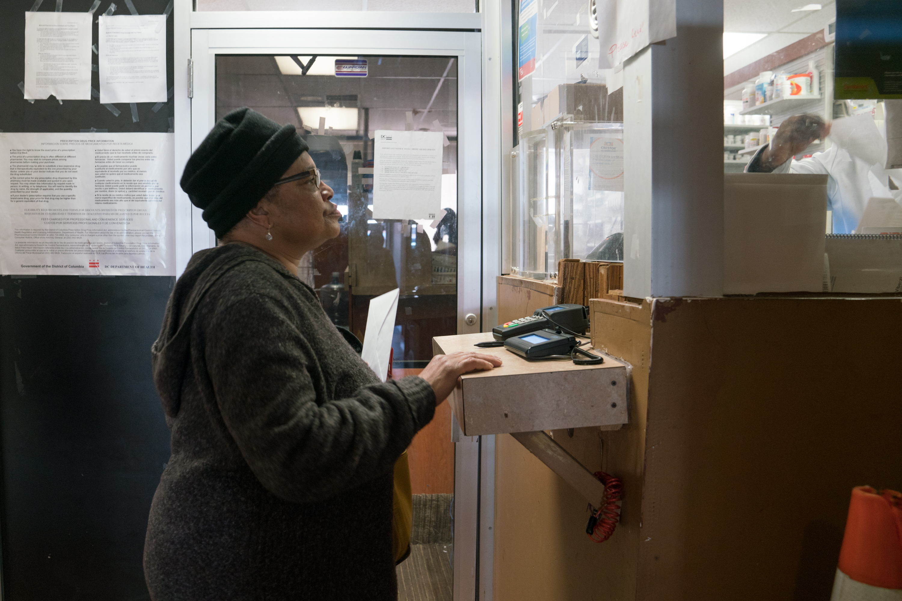 Pauletta Jackson drops off her prescription for Suboxone at the pharmacy just downstairs from Chapman's clinic. (Photo by Claire Harbage/NPR)