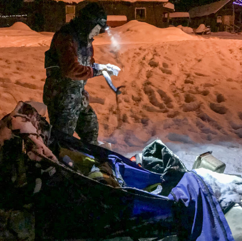 Whitehorse musher Marcelle Fressineau examines her ax at the Takotna checkpoint of the Iditarod on March 9, 2009. She says she had used the ax somewhere between Rohn and Nikolai to fend off bison.