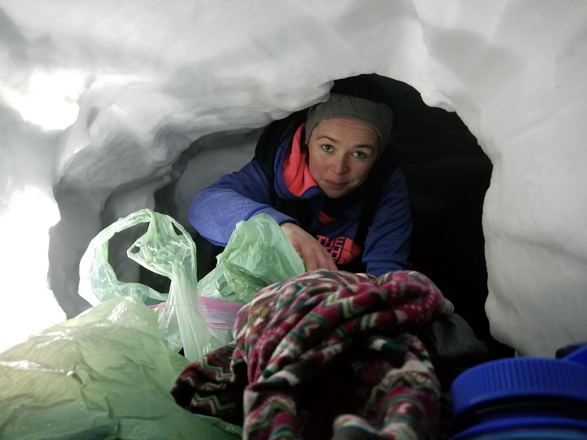 Hiker Claire Turner hunkers down in the snow cave for the night. (Photo courtesy Josh Joseph)