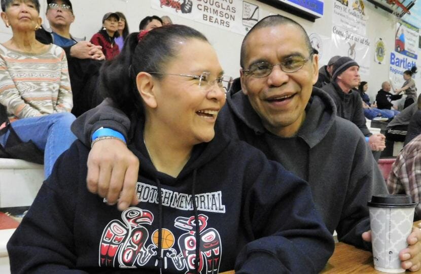 Siblings Marie and Thomas Beierly enjoy a moment during the Gold Medal Basketball Tournament, held March 18-24 in Juneau. Both are announcers during the games. (Photo by Ed Schoenfeld/CoastAlaska News)