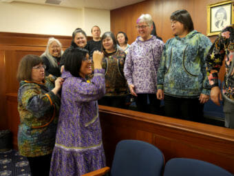 Rep. Tiffany Zulkosky, D-Bethel, greets friends and family in the Peratrovich Gallery of the Alaska State Capitol as Rep. Harriet Drummond, D-Anchorage, adjusts the hood of Zulkosky’s kuspuk on March 9, 2018. Zulkosky’s mother, also wearing a purple kuspuk, was one of many there to celebrate with her. The House speaker had just sworn Zulkosky in as the newest member of the Alaska House of Representatives.