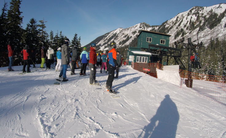 Skiers and snowboarders line up for the Ptarmigan chairlift at Eaglecrest Ski Area in March 2018.