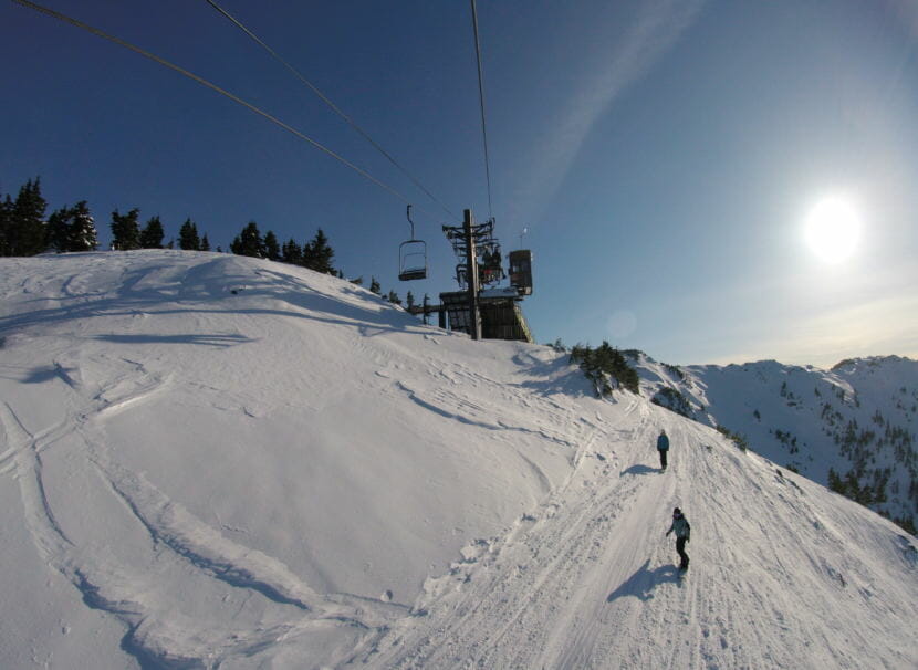 Snowboarders head down upper Hillary‘s run after getting off the Ptarmigan chairlift at Eaglecrest Ski Area in March 2018.