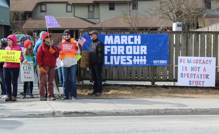 Protesters gather outside the Juneau offices of Sens. Lisa Murkowski and Dan Sullivan.