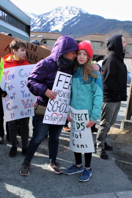 A mother embraces her daughter at a protest against gun violence on Saturday, March 24, 2018. (Photo by Adelyn Baxter/KTOO)