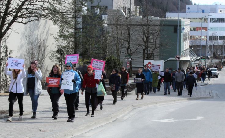 March for Our Lives protesters walk toward the Alaska State Capitol on March 24, 2018.