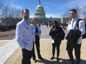 These medical students were making a Hill visit to advocate for a bill to aid the homeless. “We wanted to look official,” one said, explaining the lab coats. (Photo by Liz Ruskin/Alaska Public Media)