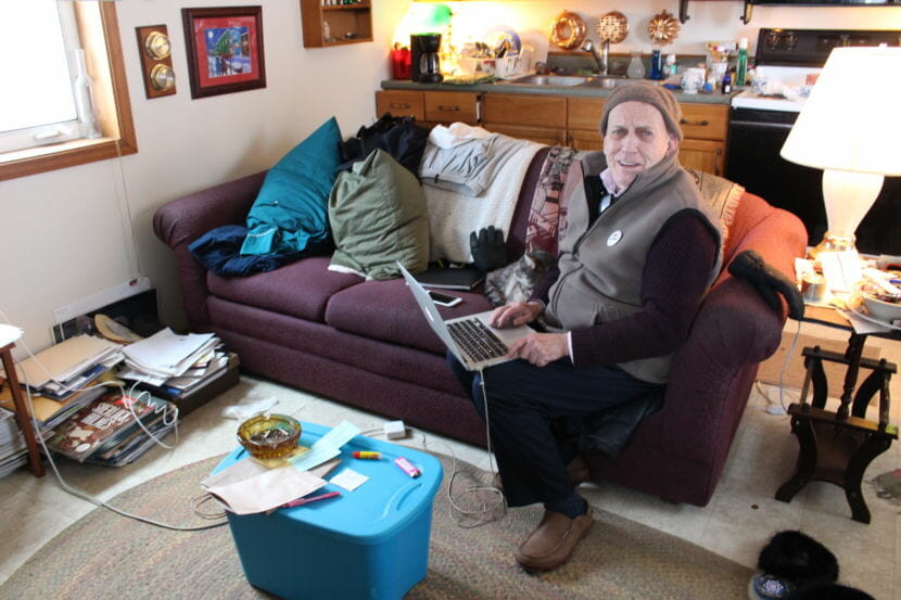 Richard Beneville rents his house in Nome. He shares the space with his cat, Ollie. (Photo by Elizabeth Jenkins/Alaska's Energy Desk)