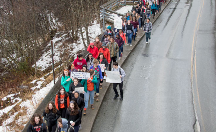 Students walk on Calhoun Avenue to the Alaska State Capitol during a walk out protest in Juneau on Wednesday, March 14, 2018.