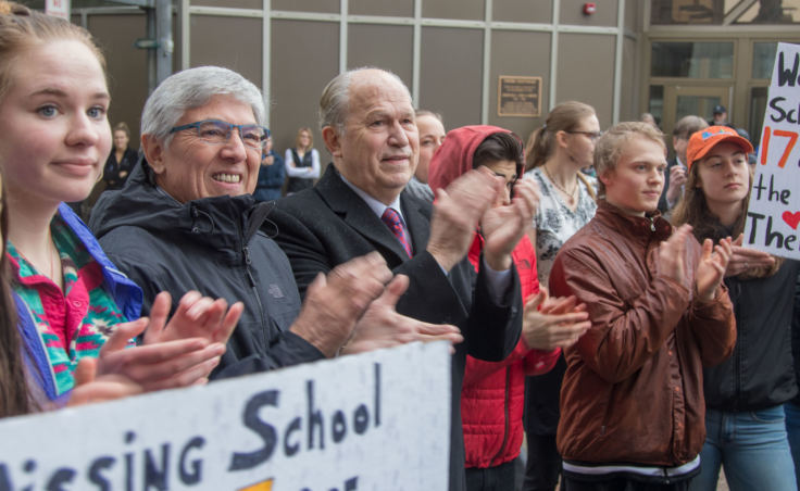 Lt. Gov. Byron Mallott, second from left, and Gov. Bill Walker, center, applaud at a student walkout protest at the Alaska State Capitol building in Juneau on Wednesday, March 14, 2018.