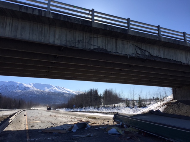 A small building on a semitrailer collided with a bridge over the Glenn Highway on Wednesday, March 21, 2018, forcing the highway’s closure.