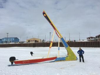 Eric Whitney stands next to the tripod he constructed for the Kuskokwim Ice Classic. The tripod was erected on the river ice in front of the Bethel seawall on March 21, 2018.
