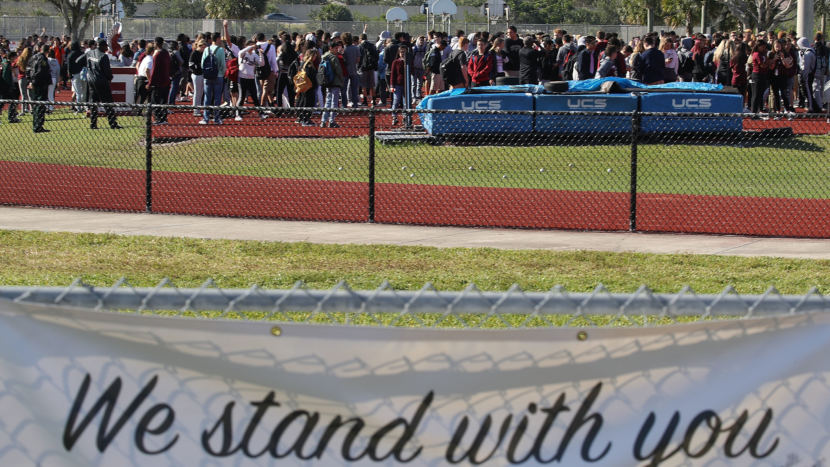 Students from Marjory Stoneman Douglas High School gather on the football field on Wednesday to honor the memories of 17 people who were killed during a mass shooting at the school in Parkland, Fla., on Feb. 14.