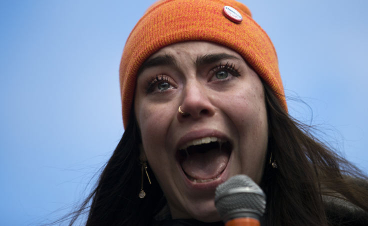 Scout Smissen, a 17-year-old junior at Roosevelt High School becomes emotional while speaking to a crowd of hundreds at Red Square on the University of Washington campus in Seattle.