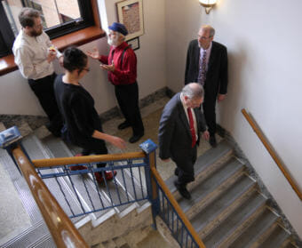 House Speaker Bryce Edgmon, D-Dillingham, front right, makes his way down from Senate Finance Co-Chair Lyman Hoffman’s office to the Speaker's Chambers in the Alaska Capitol on April 25, 2018. He was on his way to a House Majority caucus meeting accompanied by his aide, Amory Lelake, and Rep. John Lincoln’s aide Larry Persily. Reps. Lance Pruitt, R-Anchorage, and Paul Seaton, R-Homer, carry on a conversation in background. (Photo by Skip Gray/360 North)