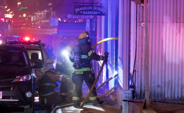 Capital City Fire/Rescue fights a fire in the 200 block of North Franklin Street on the evening of Monday, April 16, 2018. (Photo by Mikko Wilson/KTOO)