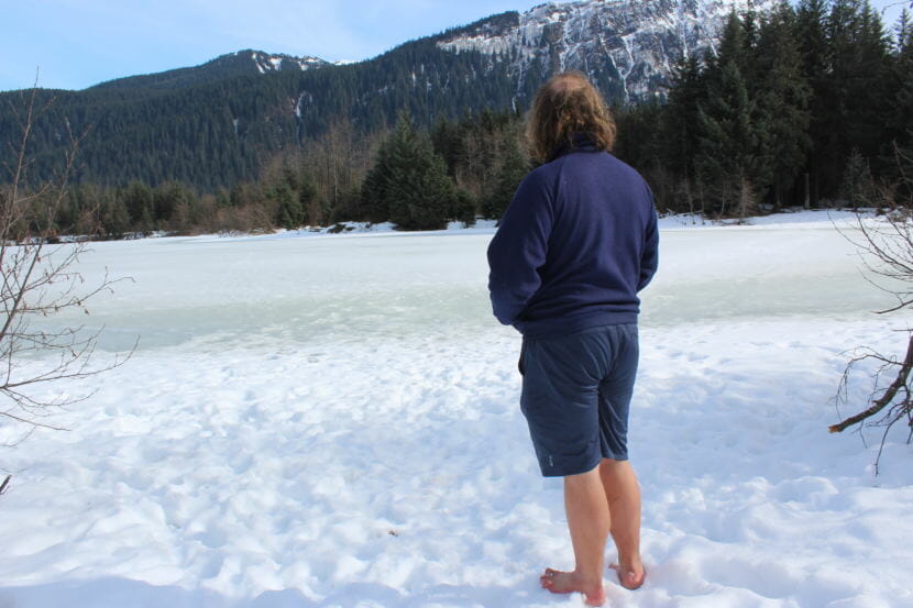 "Barefoot Guy" Ezra Strong looks out on Dredge Lake during a hike. (Photo by Adelyn Baxter/KTOO)