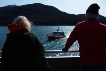 Volunteers watch as a U.S. Coast Guard vessel approaches the St. Nicholas during a training exercise. (Photo by Adelyn Baxter/KTOO)