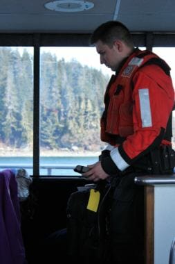A member of the U.S. Coast Guard Sector Juneau use a radiation detector to locate a device aboard the St. Nicholas during a training exercise. (Photo by Adelyn Baxter/KTOO)