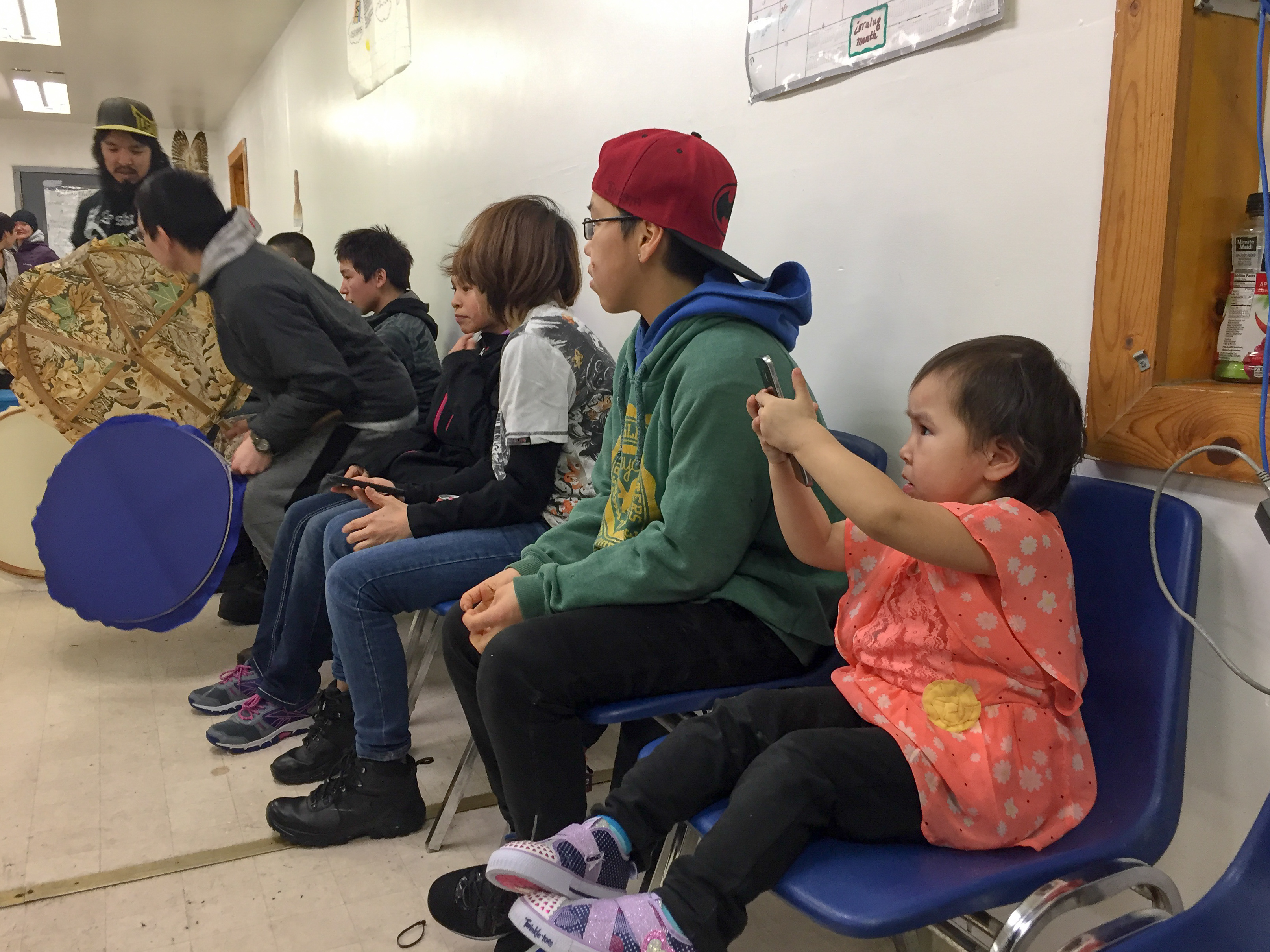 A child practices her photography skills during dance practice for the Hooper Bay youth group. (Photo by Anne Hillman/Alaska Public Media)