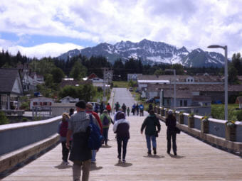 Tourists walk on the cruise ship dock towards Haines’ Fort Seward. (Photo by Emily Files/KHNS)