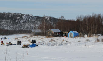 The austere Iditarod checkpoint, with just two major shelter structures, and tents or converted out buildings set up for Iditarod. (Photo by Zachariah Hughes/Alaska Public Media)