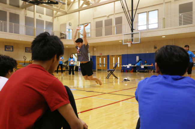 Kyle Worl demonstrates the Kneel Jump event for participants at the 2018 Traditional Games held at the University of Alaska Southeast Recreation Center. The contest was sponsored by Sealaska Heritage, Central Council of Tlingit and Haida Indian Tribes of Alaska and Wooch.Een in collaboration with Goldbelt Heritage. (Photo by Annie Bartholomew/KTOO)