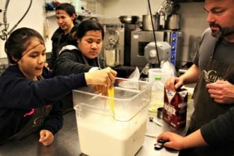 Students on a cultural exchange trip from Noorvik Aqqaluk School make ice cream with Marc Wheeler in the kitchen at Coppa in Juneau. (Photo by Adelyn Baxter/KTOO)