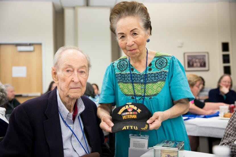 Joseph Sasser and Helen Ford share Attu mementos at a 75-year anniversary commemoration of the Battle of Attu in 2018.