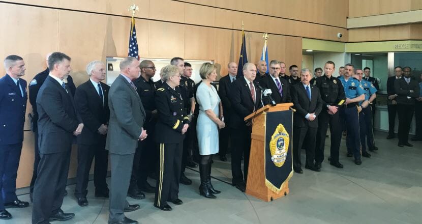 Alaska Gov. Bill Walker, flanked by more than 30 law enforcement officials, holds a press conference on Friday, May 18, 2018, at the state crime lab in Anchorage.