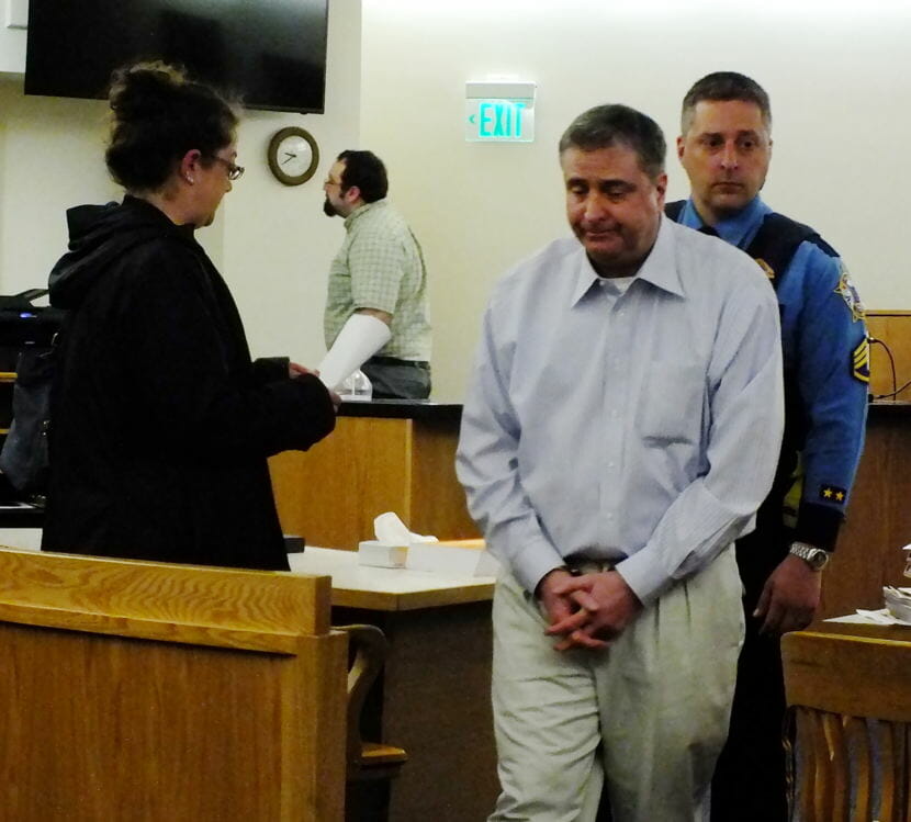 Mark DeSimone is led away from the courtroom May 11, 2018, after a jury convicts him on a charge of first-degree murder. DeSimone stood trial in Juneau Superior Court on charges related to the May 2016 death of Duilio "Tony" Rosales in Excursion Inlet. DeSimone‘s attorney, Assistant Public Defender Deborah Macaulay, is at left. (Photo by Matt Miller/KTOO)