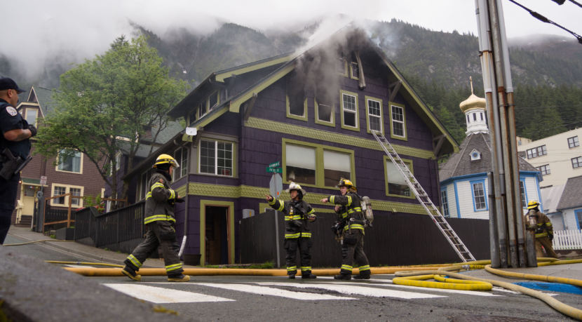 Firefighters work outside the house at the corner of 5th and Franklin after the fire there on May 28, 2018. 