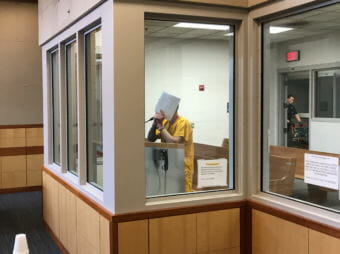 Vance Peronto, 57, covers his face in Anchorage Jail Court on Monday, April 30, 2018. Peronto was an Alaska State Trooper when he was charged with attempted sexual abuse of a minor.