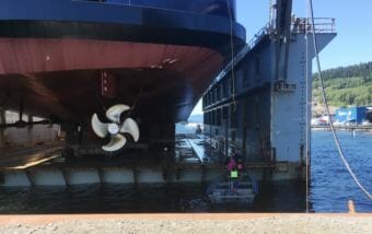 Vigor Alaska shipyard workers board the drydock from a skiff before the ferry Tazlina is lowered into the water for the first time on May 16, 2018 in Ketchikan.