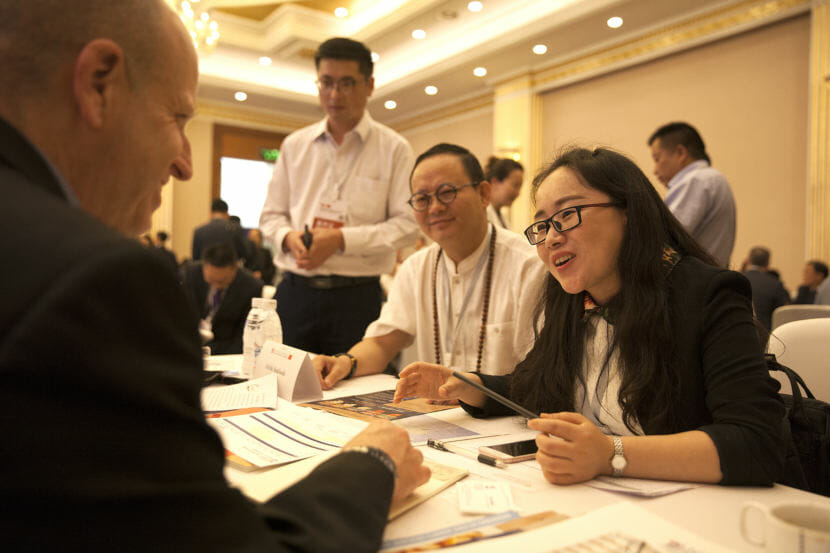 Ron Risher of Icicle Seafoods talk to Crescent Xuan, Manager of International Trade for the Sichuan Jinggong Flavor Co., during a “speed dating” event designed to bring companies with Alaska products to Chinese consumers on Tuesday, May 23, 2018, in Chengdu, China. (Photo by Rashah McChesney/Alaska’s Energy Desk)