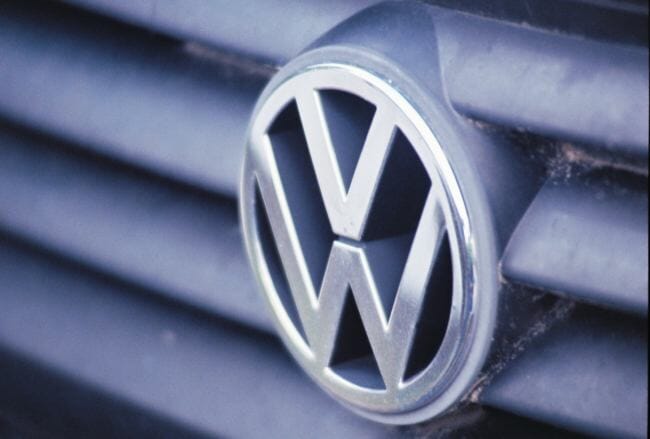 The Volkswagen emlbem on the grill of a Jetta.
