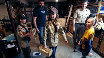Tatum Weir, center, carries a tool box she built as her twin brother, Ian, left,, follows after a Cub Scout meeting in Madbury, N.H., on March 1. For more than a century, the Boy Scouts of America's flagship program for older boys has been known as the Boy Scouts. With girls soon entering the ranks, the name will change to "Scouts BSA." (Photo by Charles Krupa/Associated Press)